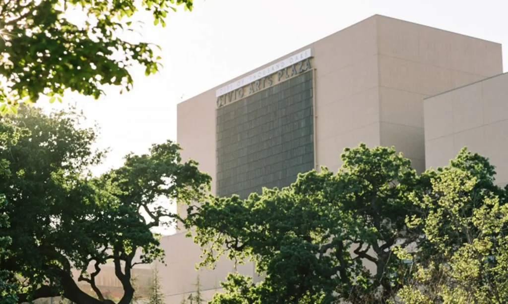 Close-up of exterior of Civic Arts Plaza with trees in the foreground.