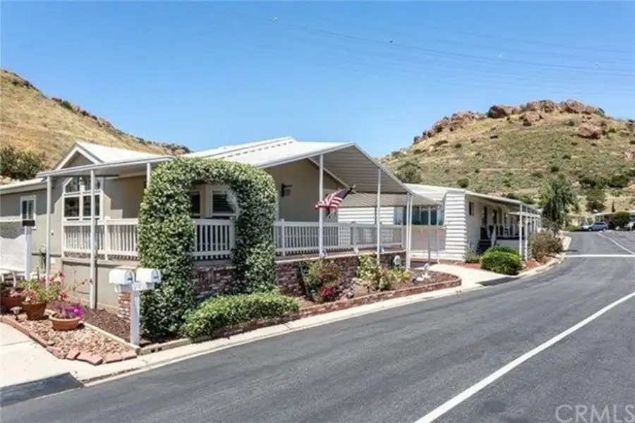 Multiple mobile homes in a mobile home park with paved roads.