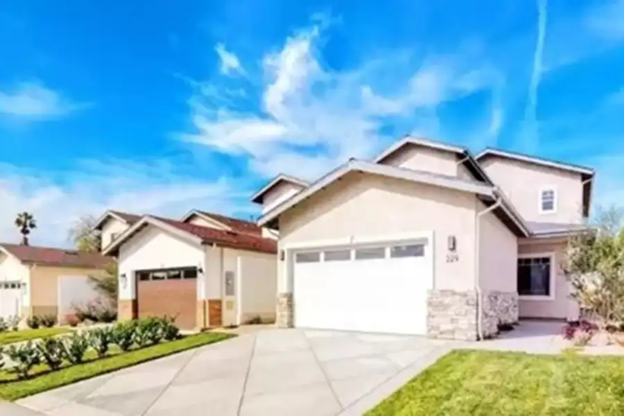 Three single-family homes depicted closely to one another, each being two-stories in height.