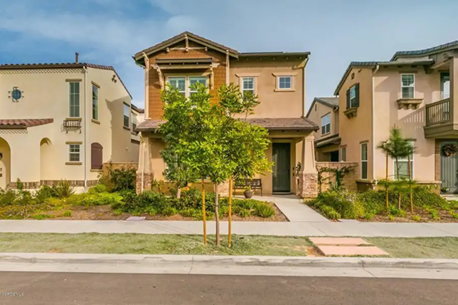 Multiple two-story single-family homes in a variety of architectural styles built close to one another.